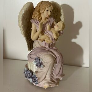 Angel holding baby music box decoration